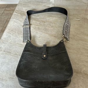 Crossbody faux leather purse with guitar strap. Grey